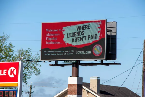 billboard that reads "Welcome to Alabama's Flagship Institution... Where Legends Aren't Paid"